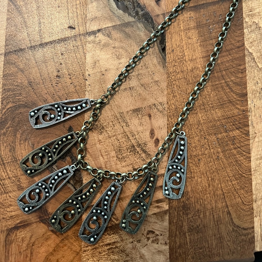 Bohemian charm necklace in bronze and pewter coloring. 17” chain 1 1/2” charms